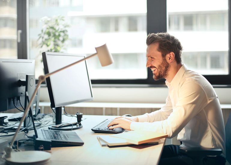 Man writing email at desk