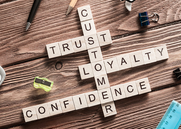 Scrabble tiles showing words: customer, trust, loyalty, confidence