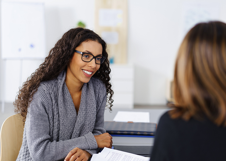 Two business women talking in office