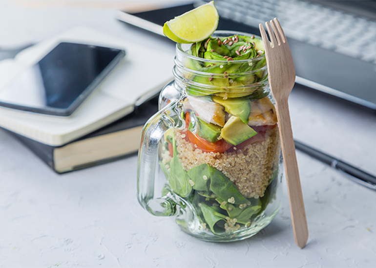 Healthy salad lunch in a jar on desk