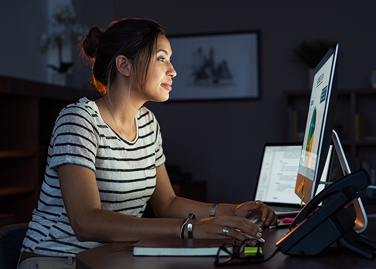 Casual woman working late at computer