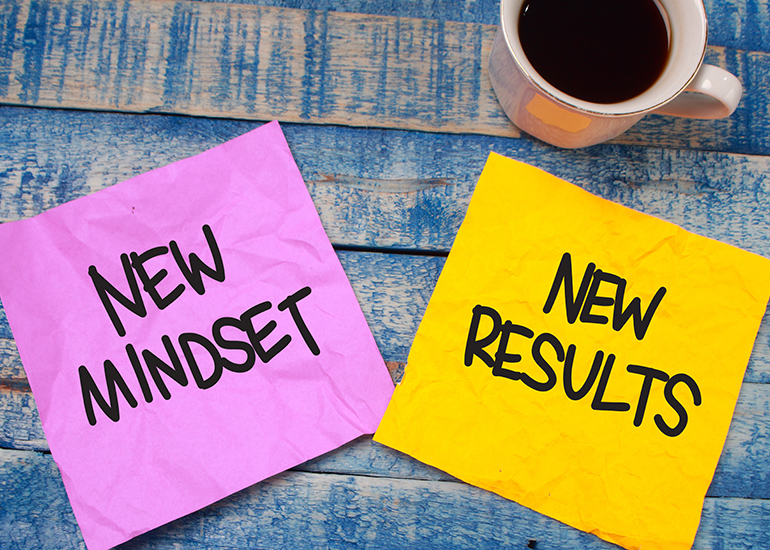 Post-it notes with the words 'new mindset, new results'