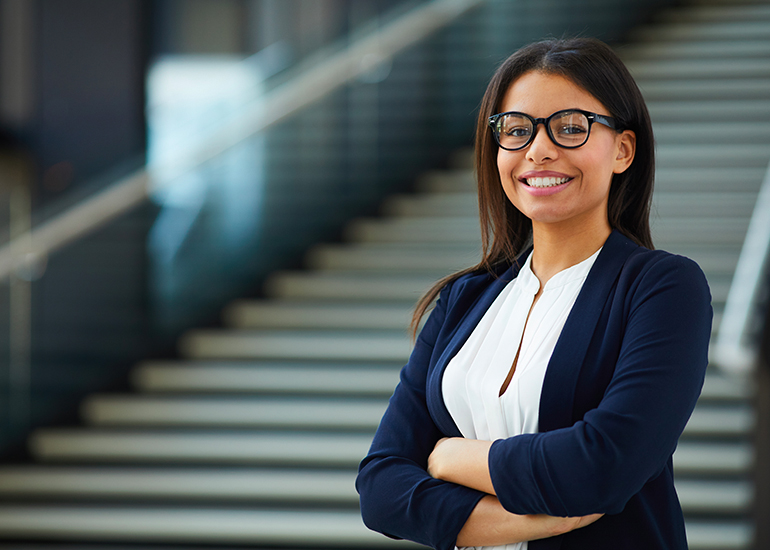 Young business woman standing outside with arms crossed