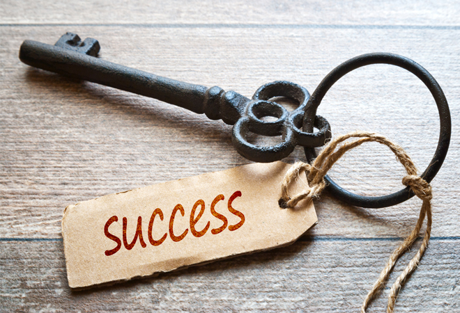 key on a ring with a cardboard tag reading 'success'
