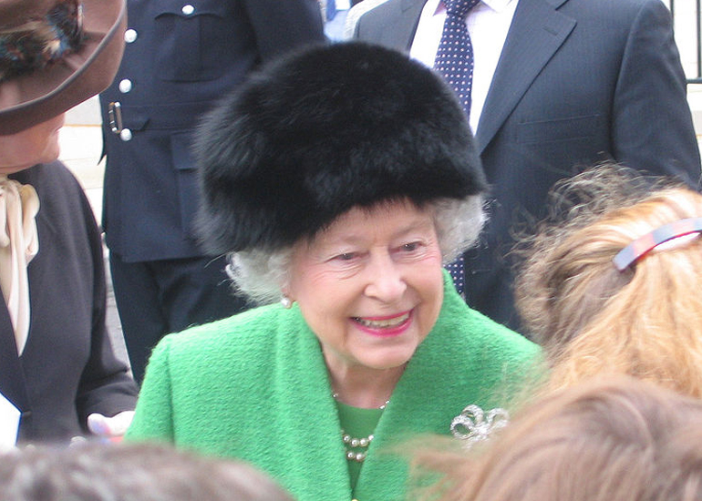 Queen Elizabeth II in green, greeting a crowd