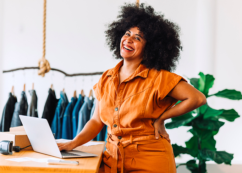 happy worker at counter in fashion store