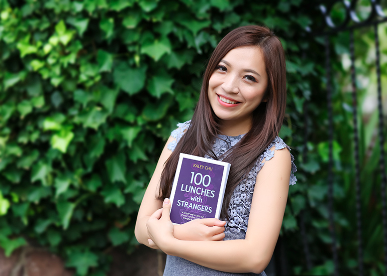 Kaley Chu with book, '100 Lunches With Strangers'