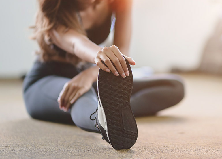 young woman stretching before exercise