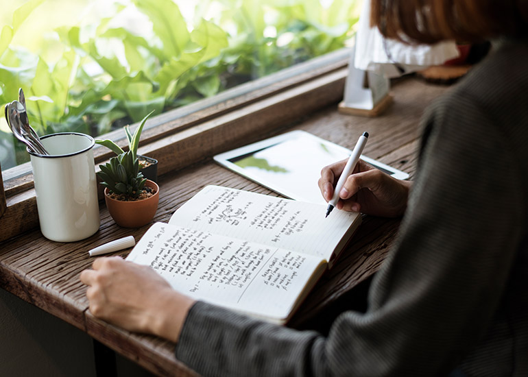 woman writing in journal