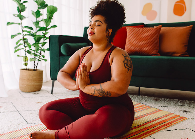 woman practicing yoga or meditation at home