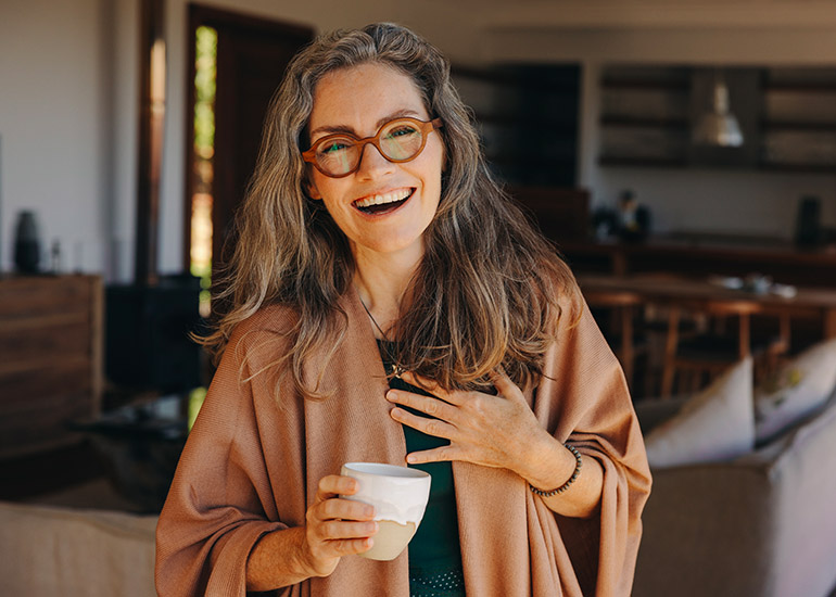 happy older woman feeling relaxed in lounge bar