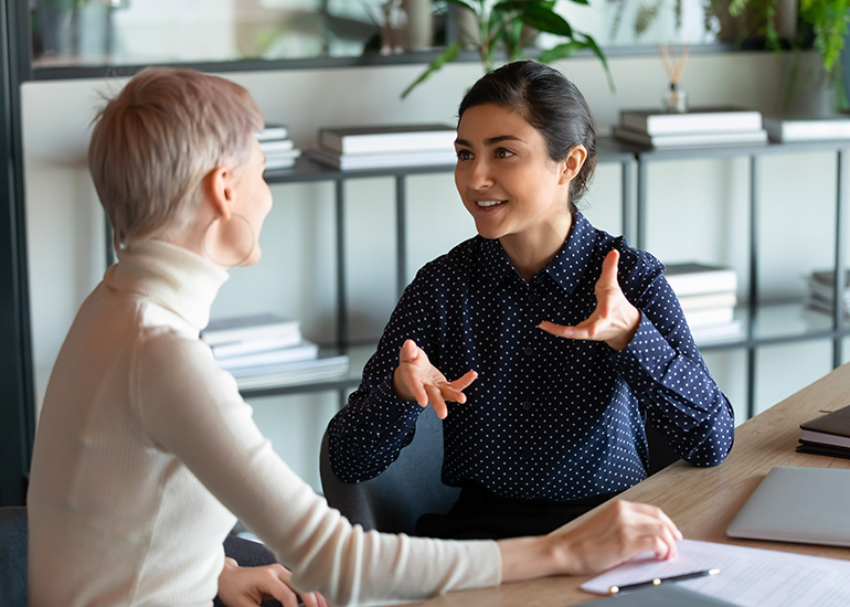 Two women talking in office