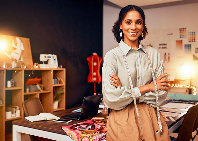 Woman in home office sewing or fashion studio