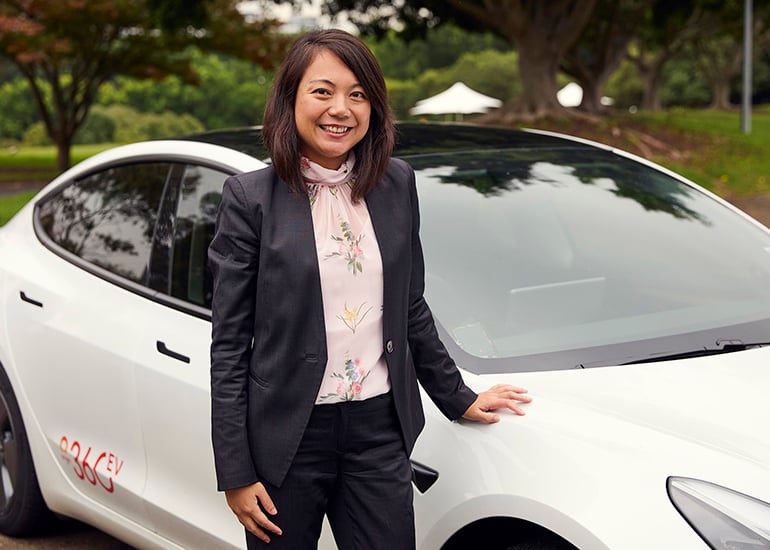 Chau Le with electric vehicle (EV)