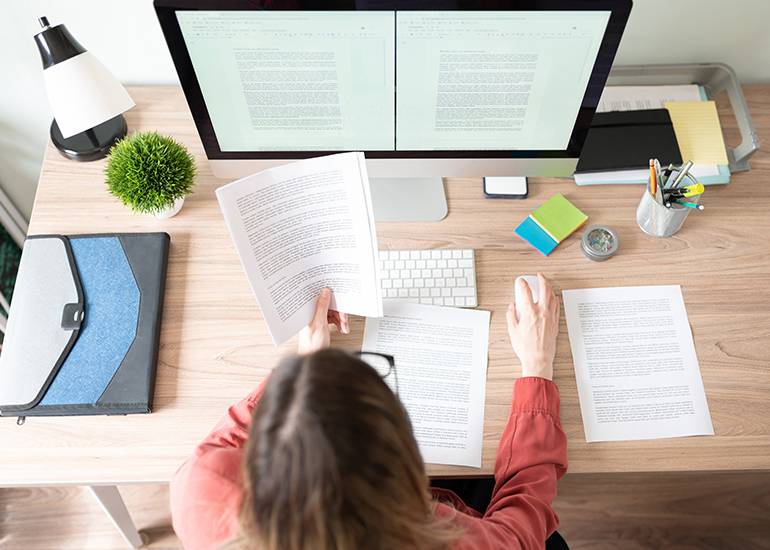 Woman at desk writing digital content