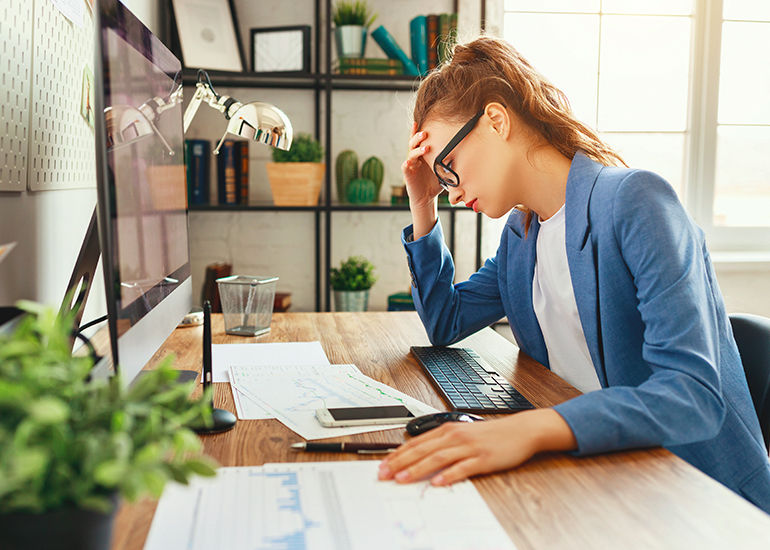 Stressed, sad woman at desk