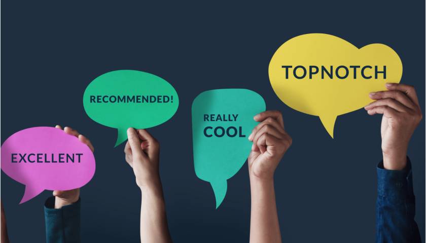 Hands holding comment bubbles with words that would empower reputation