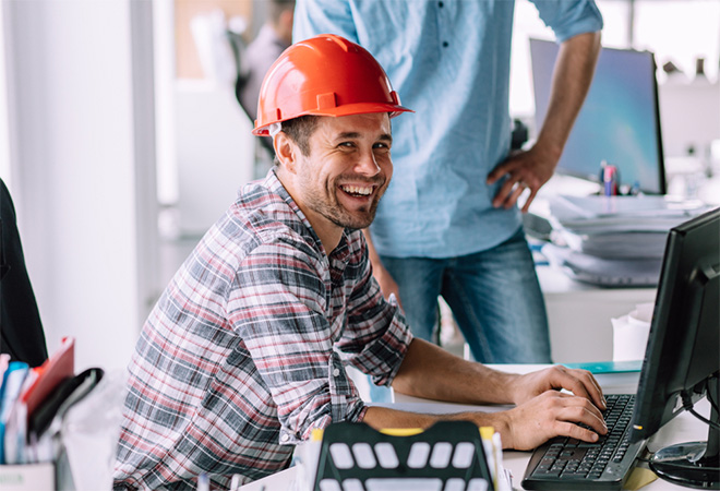 happy tradie using computer
