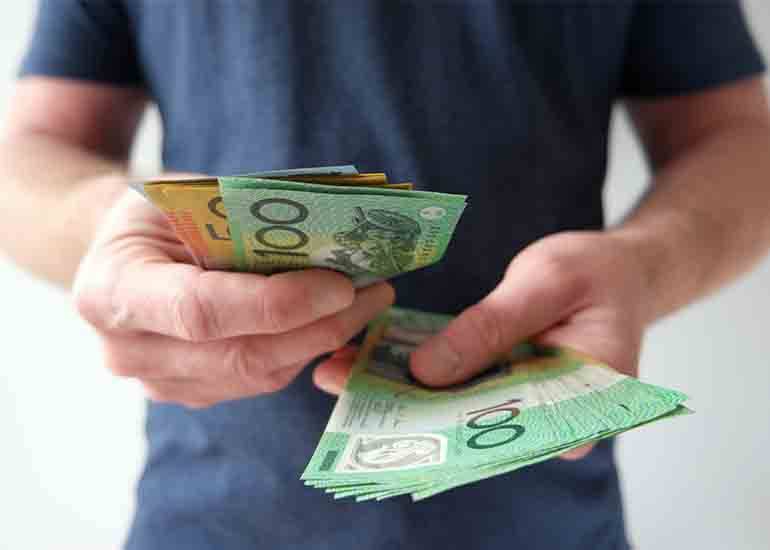 man counting money- 100 dollar bills