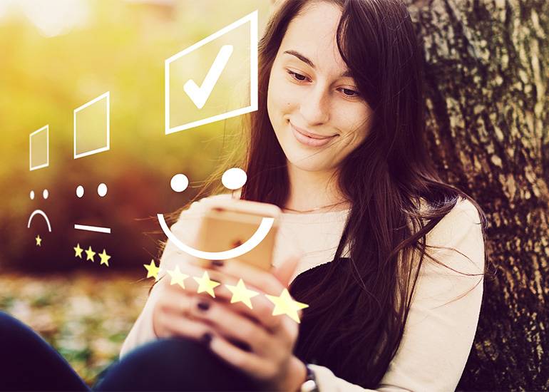 Smiling woman using mobile phone happy UX customor experience