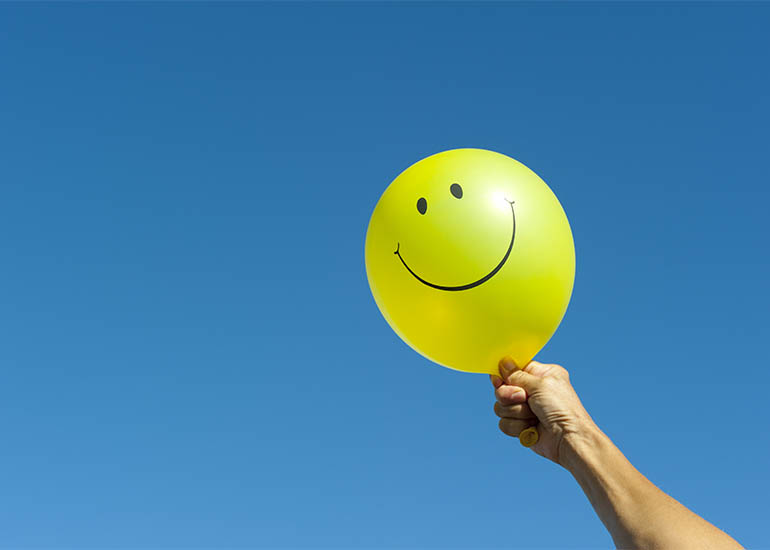 yellow balloon with smiley face