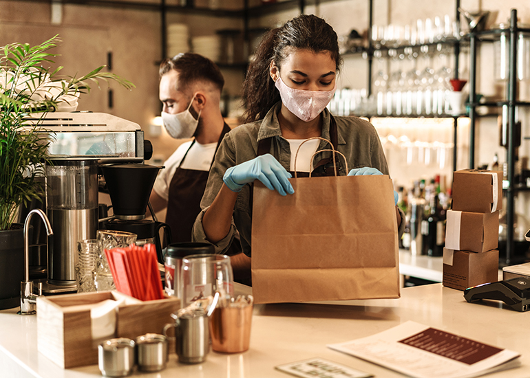Baristas wearing masks and gloves due to Covid