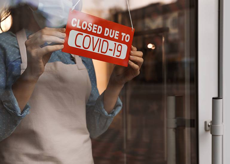 Sign on store front door: 'Closed due to COVID'