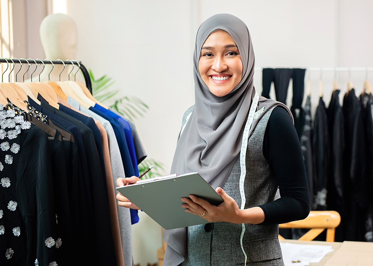 happy Muslim dress shop owner