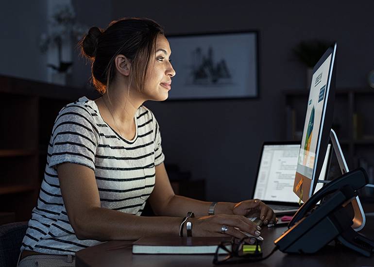 Casual woman working late at computer
