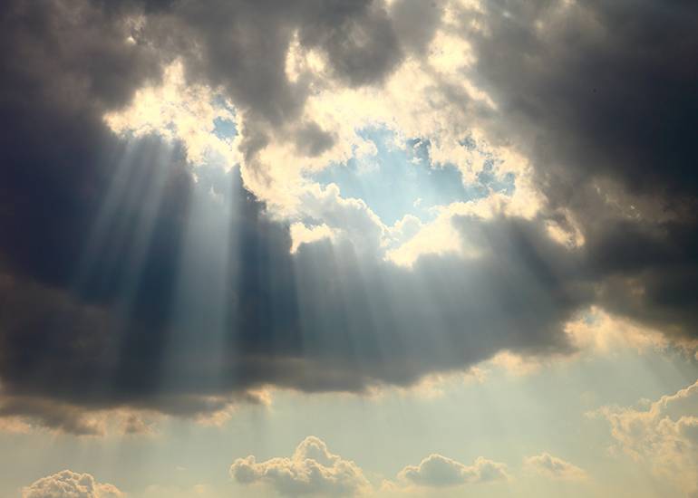 Sunbeams shinging through dark clouds