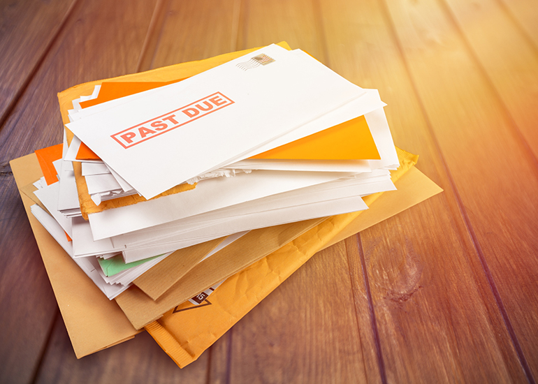 Stack of overdue and late bill envelopes