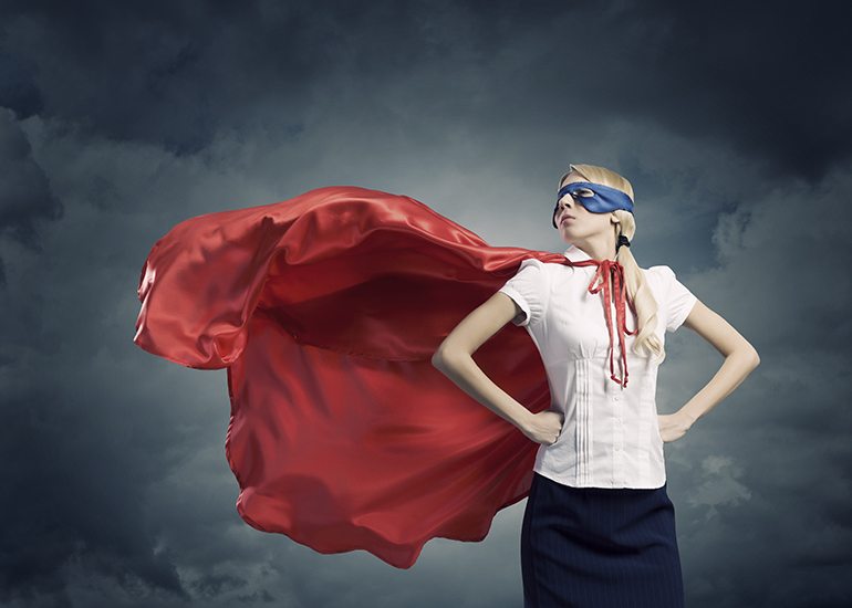Brave, strong woman wearing superhero cape and mask