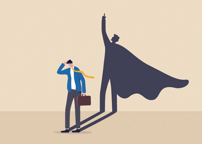 Cartoon of businessman looking doubtful while his shadow wears a superhero cape