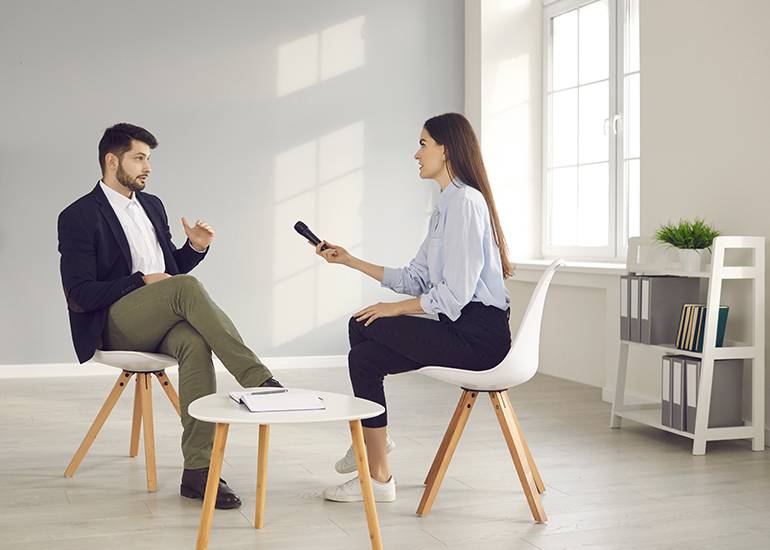 Interview between two people sitting indoors