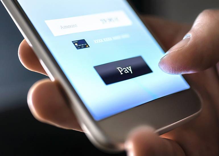 Clicking ‘pay’ button on smart phone