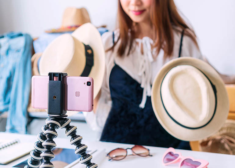 woman creating video with smartphone in store