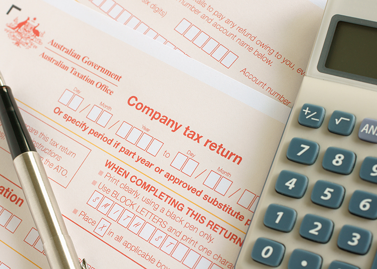 company tax return form with calculator and pen