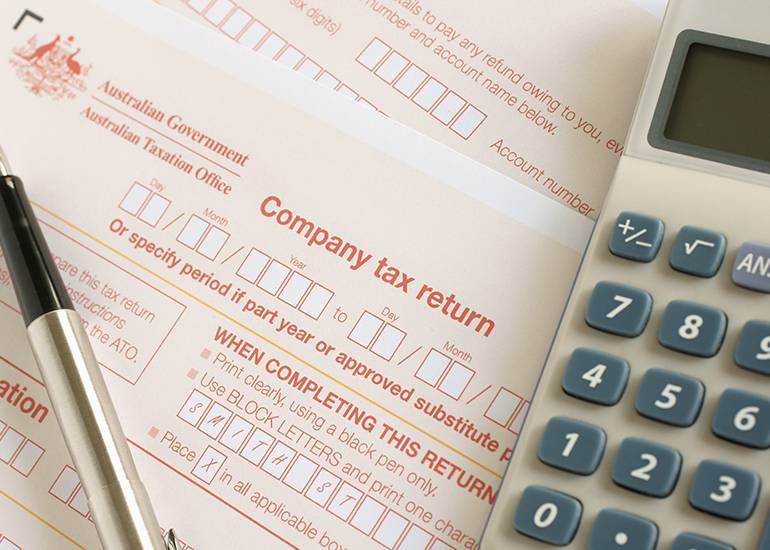company tax return form with calculator and pen
