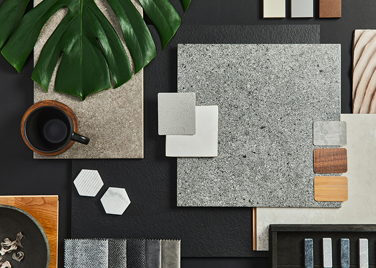 Mood board flatlay with leaves and various wood and fabric textures and colours