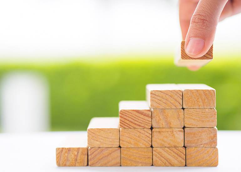wooden blocks stacked in five piles