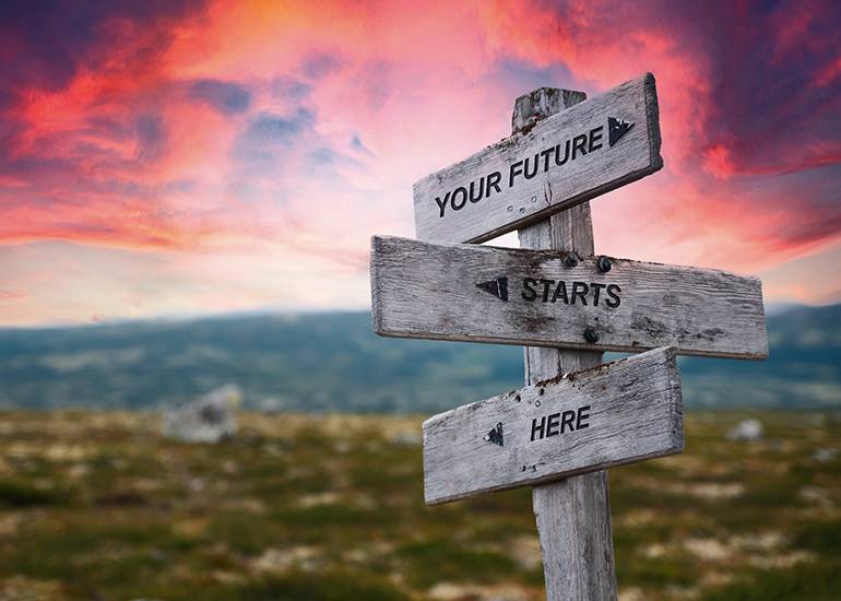 ‘Your future starts here’ text on wooden signpost