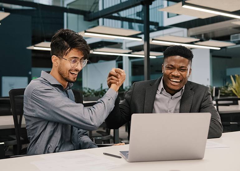 Business partners celebrating a business win