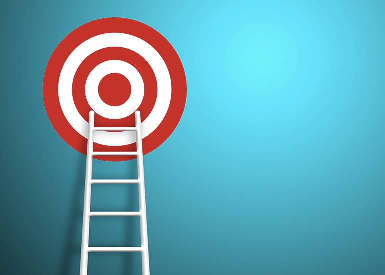 ladder leading up to target on blue wall