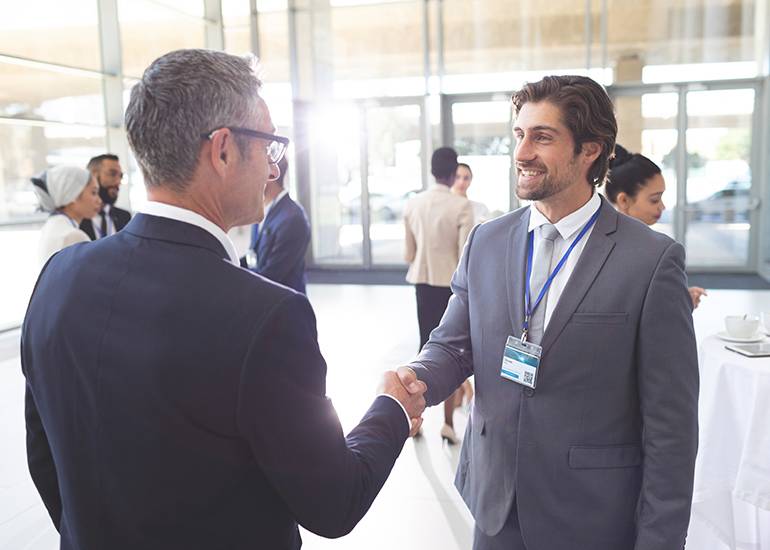 Men shaking hands at networking event