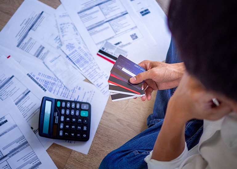 Person calculating tax and bills, feeling confused