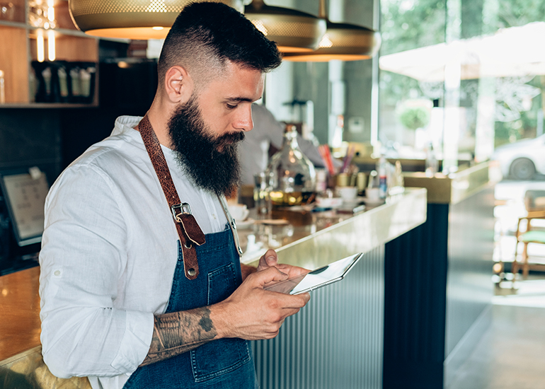 Hipster bar owner using tablet