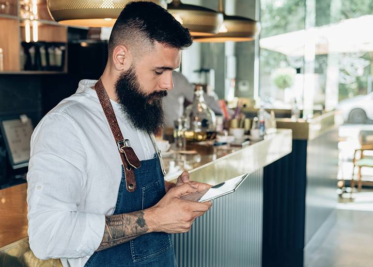 Hipster bar owner using tablet