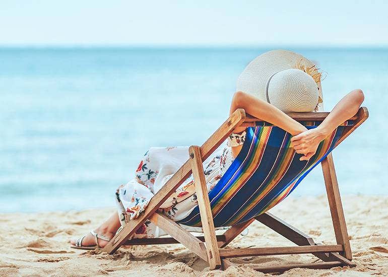 Woman relaxing in beach chair in summer