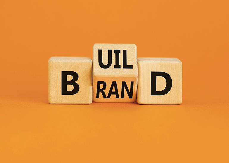 Wooden blocks showing the words 'build brand'