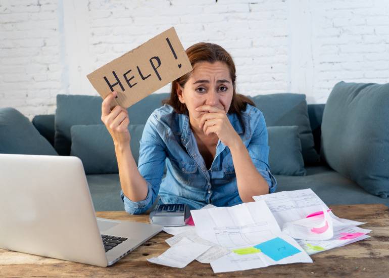 woman business owner holding help sign- cash flow crisis